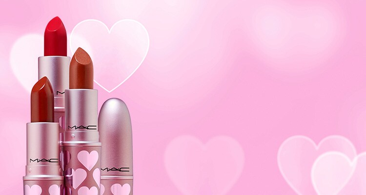 Tower of lipsticks on a pink and heart background